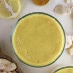Image of a glass of baobaob smoothie with giinger and baobab fruit pulp in the background